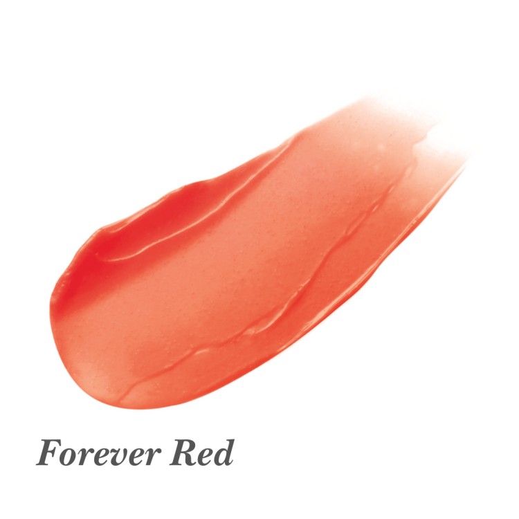 Na obrázku je vzorek barvy produktu Jane Iredale Just Kissed Lip and Cheek Stain v odstínu Forever Red. Barva je teplá, poloprůhledná červená s jemným leskem.