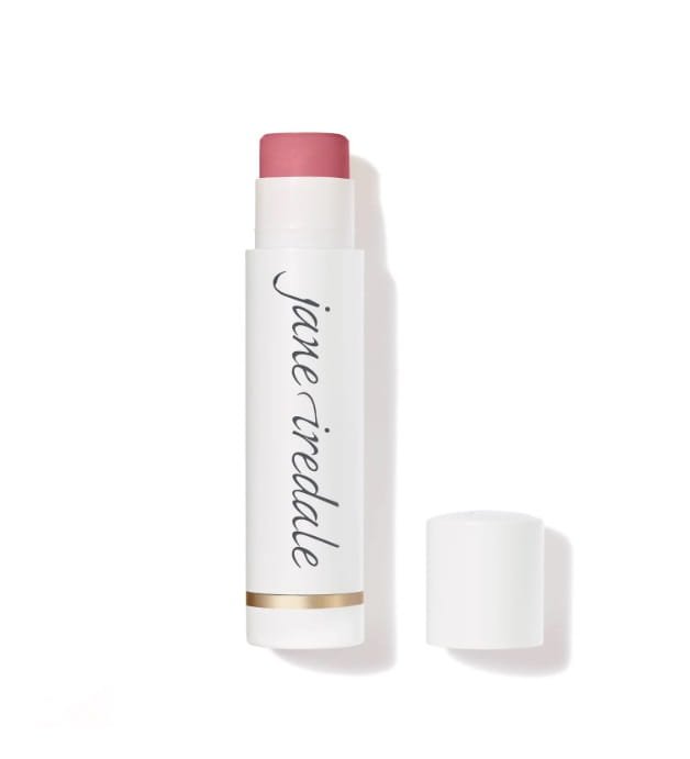 Na obrázku je balzám na rty značky jane iredale Lip Drink. Produkt má elegantní bílé balení s logem značky a zlatým akcentem u spodní části.