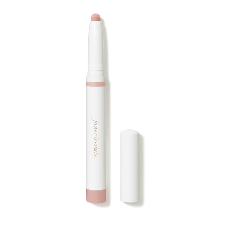 Na zdjęciu widoczna jest biała kredka eye shadow stick  automatyczne cienie do powiek w sztyfcie marki Jane Iredale, z lekko różowymi elementami.