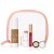 Elegantní sada Jane Iredale zabalená v průhledné kosmetické taštičce s růžovým rámečkem. Uvnitř se nachází: tekutý make-up s kapslemi, tvářenka ve formě tyčinky, lesk na rty, korektor v kelímku a rtěnka. Celek působí svěže a luxusně.