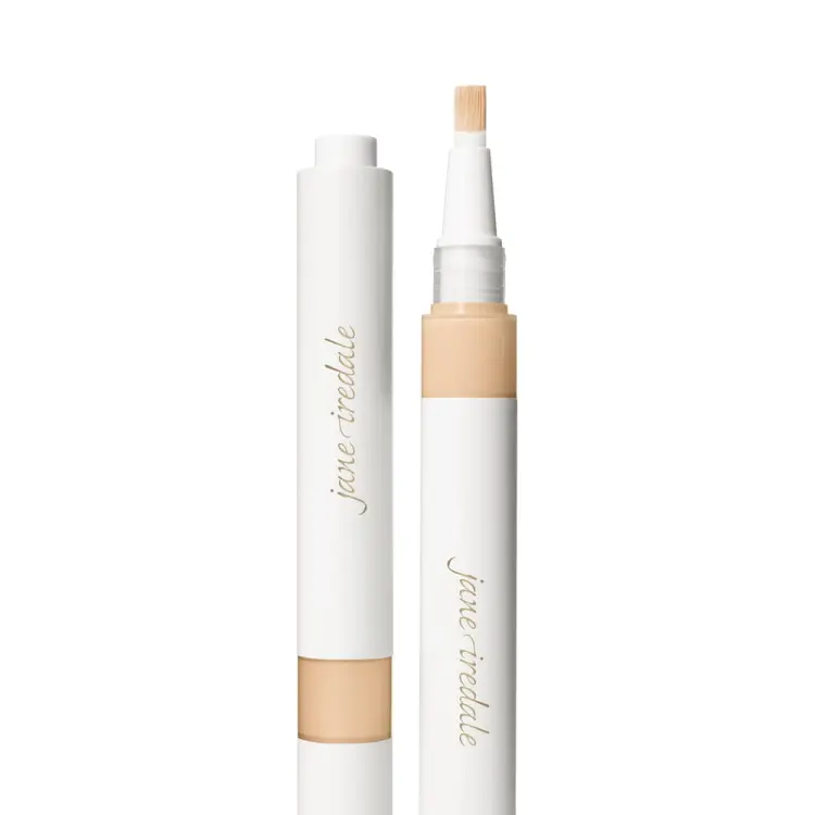Na fotografii je korektor se štětečkovým aplikátorem značky jane iredale. Je vidět otočný obal s vestavěným aplikátorem ve formě štětečku a uzávěrem. Produkt je určen k rozjasnění očního okolí a zakrytí tmavých kruhů pod očima.